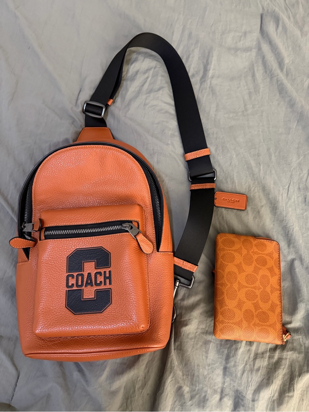 Coach Orange Leather Sling Bag with Black Strap and wristlet new without tags
